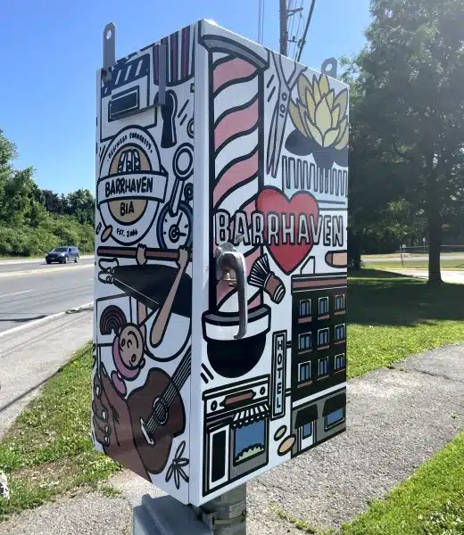 Picture of a raised metal utility box, wrapped in vibrant illustrations.